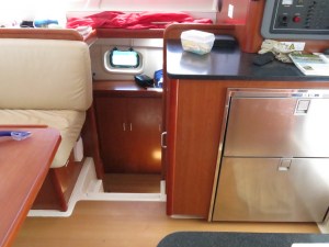 View from main salon down companionway to starboard hull, fridge and freezer on right