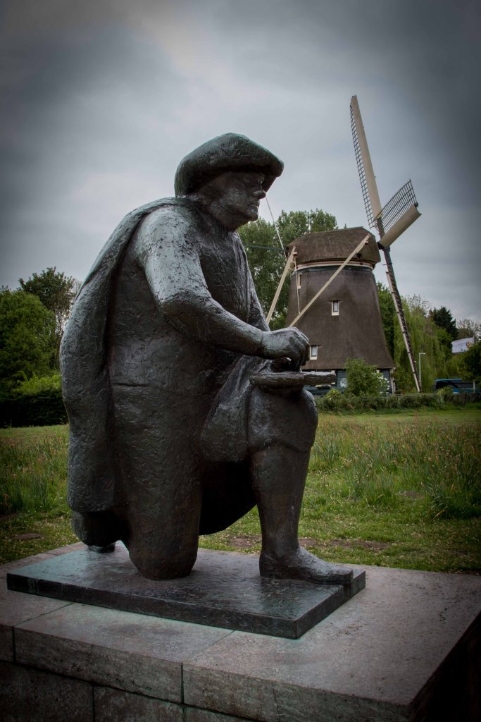 Statue of Rembrandt with windmill in background